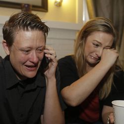 Same sex couple Lisa Kirk, left, and Lena Brancatelli, right, cry while reacting to the U.S. Supreme Court's ruling on gay marriage in California, Wednesday, June 26, 2013 at their home in San Jose, Calif.  The justices issued two 5-4 rulings in their final session of the term. One decision wiped away part of a federal anti-gay marriage law that has kept legally married same-sex couples from receiving tax, health and pension benefits. The other was a technical legal ruling that said nothing at all about same-sex marriage, but left in place a trial court's declaration that California's Proposition 8 is unconstitutional.  (AP Photo/Eric Risberg)