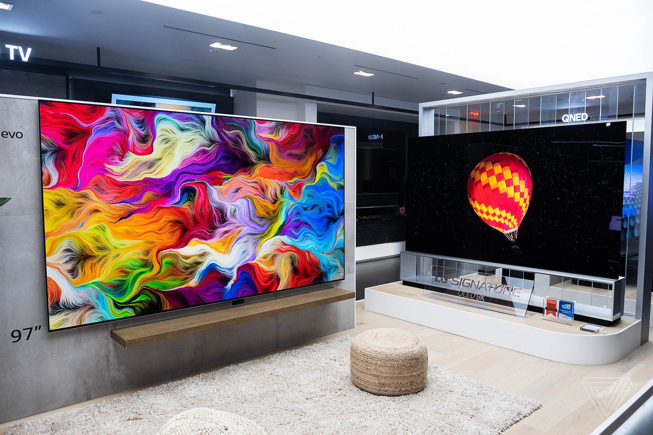 A picture of two wall-mounted LG TVs taken during CES 2022.