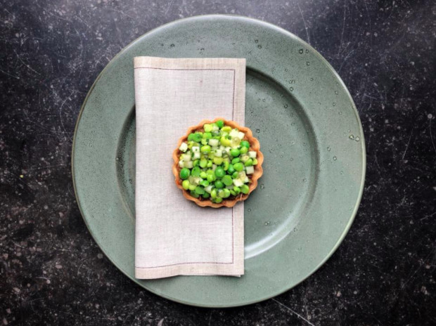 From above, a small pastry topped with chopped greens.