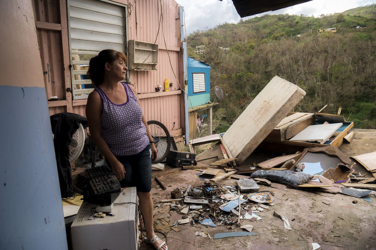 Rosana Aviles stands in the living room of her brother's hurricane destroyed house in the Juan Gonzalez neighborhood.