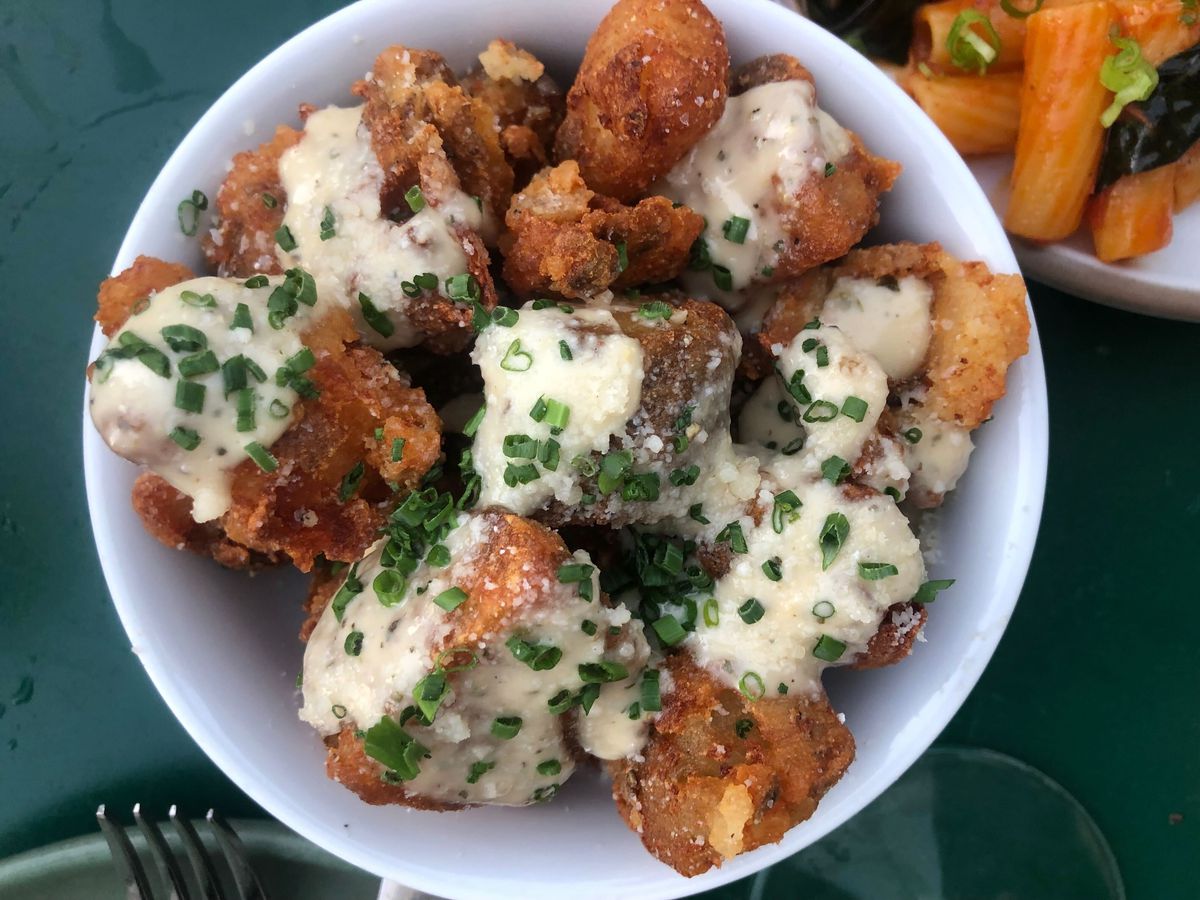 Fried potatoes topped with Italian dressing and chives.