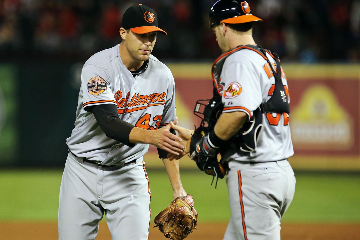 Aug 21, 2012; Arlington, TX, USA; Baltimore Orioles relief pitcher Jim Johnson (43) celebrates with catcher Matt Wieters (32) after recording the last out against the Texas Rangers at Rangers Ballpark.