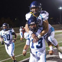 Juan Diego running back Ryan Baker hops onto the back of quarterback Zachary Hoffman after Juan Diego defeated Delta 35-21 in the UHSAA 3A state championship football game at Southern Utah University in Cedar City on Saturday, Nov. 12, 2016.