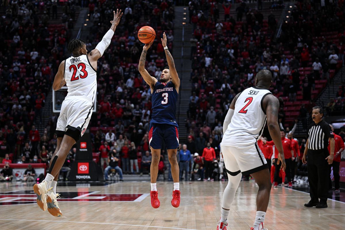 Fresno State Bulldogs guard Isaiah Hill (3) attempts a three-point basket while defended by San Diego State Aztecs forward Joshua Tomaic (23) at the end of the second overtime during the second half at Viejas Arena. Mandatory Credit: Orlando Ramirez