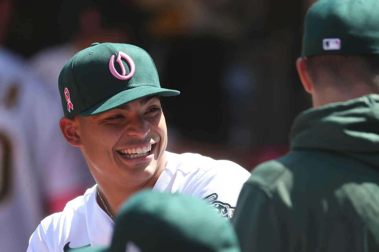 Jesus Luzardo (44) smiling in dugout with teammates during game vs Tampa Bay Rays at RingCentral Coliseum