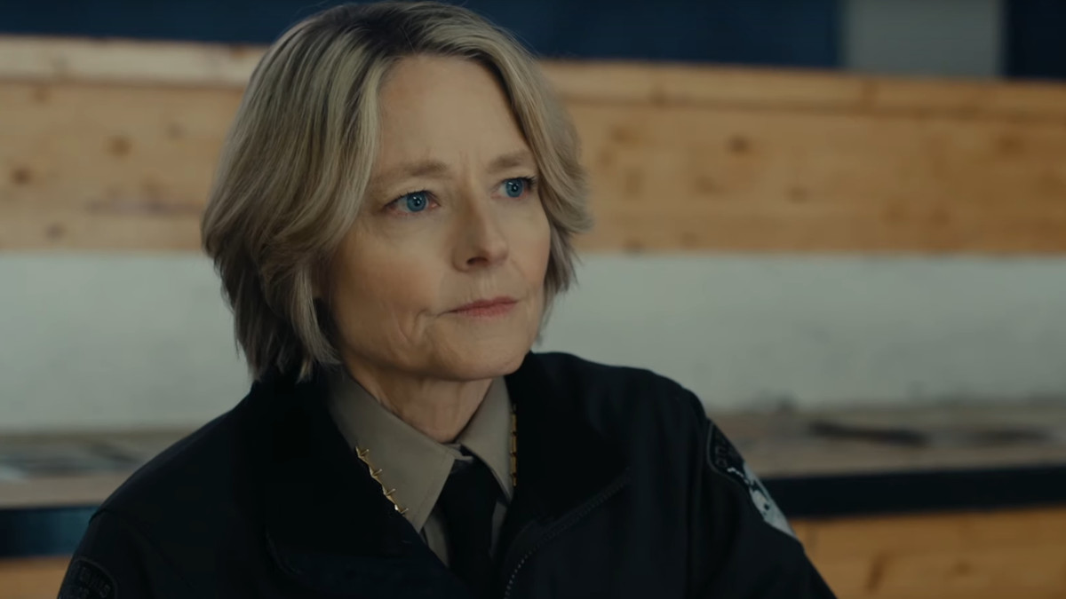Jodie Foster sitting on a bench in a police uniform in True Detective: Night Country