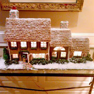 Detailed gingerbread house with snowy roof. 