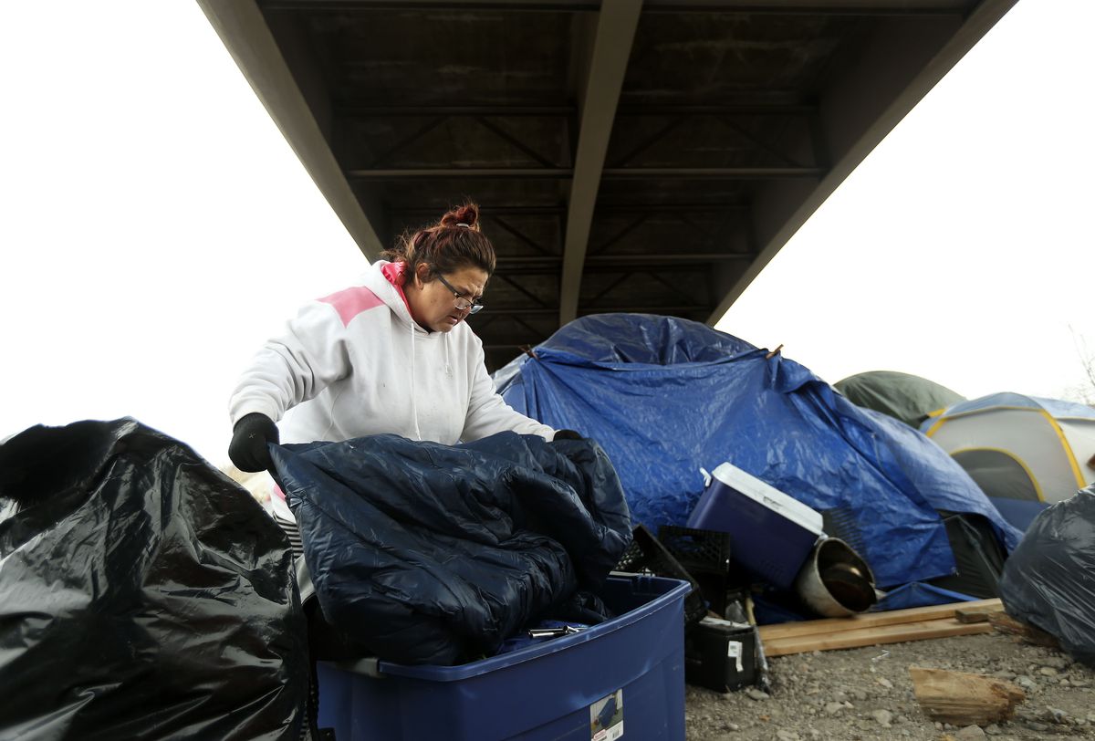 Shawna Gardner packs her belongings from her encampment in Salt Lake City on Tuesday, Feb. 9, 2021. A small group of people, including Gardner, left Camp Last Hope when its closure was announced about 10 days ago. They took refuge under a freeway overpass a couple of miles to the north. “They came by yesterday morning and shook everybody’s tents,” said Gardner, 47. “They said we had to be gone within 24 hours.”