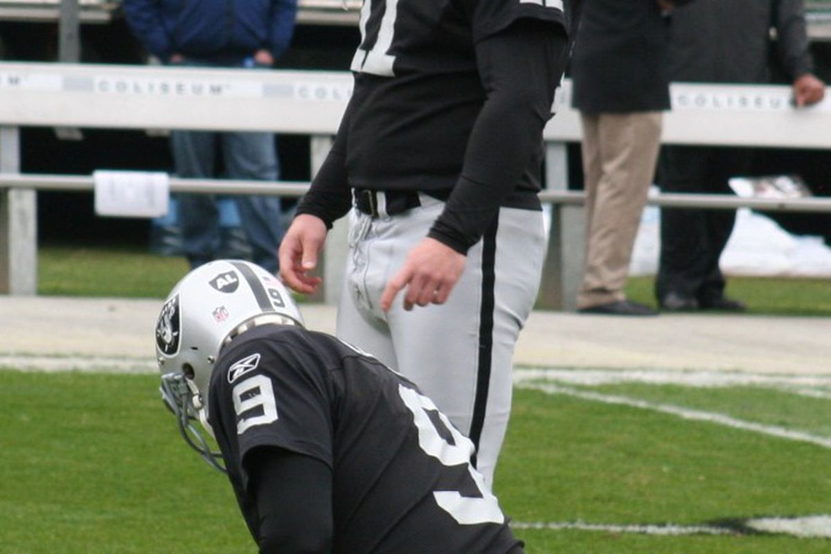 Shane Lechler and Sebastian Janikowski of the Oakland Raiders set up for a field goal attempt (photo by Levi Damien)