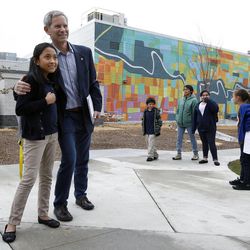 Salt Lake City Mayor Ralph Becker takes a photo with Ashley Vilchez, 10, after his tour of the Sorenson Unity Center in Salt Lake City on Wednesday, April 8, 2015.