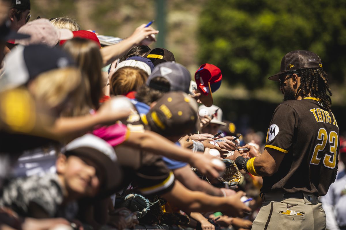 Fernando Tatis Jr. of the San Diego Padres signs autographs for fans before a spring training game against the Los Angeles Angels on March 24, 2023 at the Tempe Diablo Stadium in Tempe, Arizona.