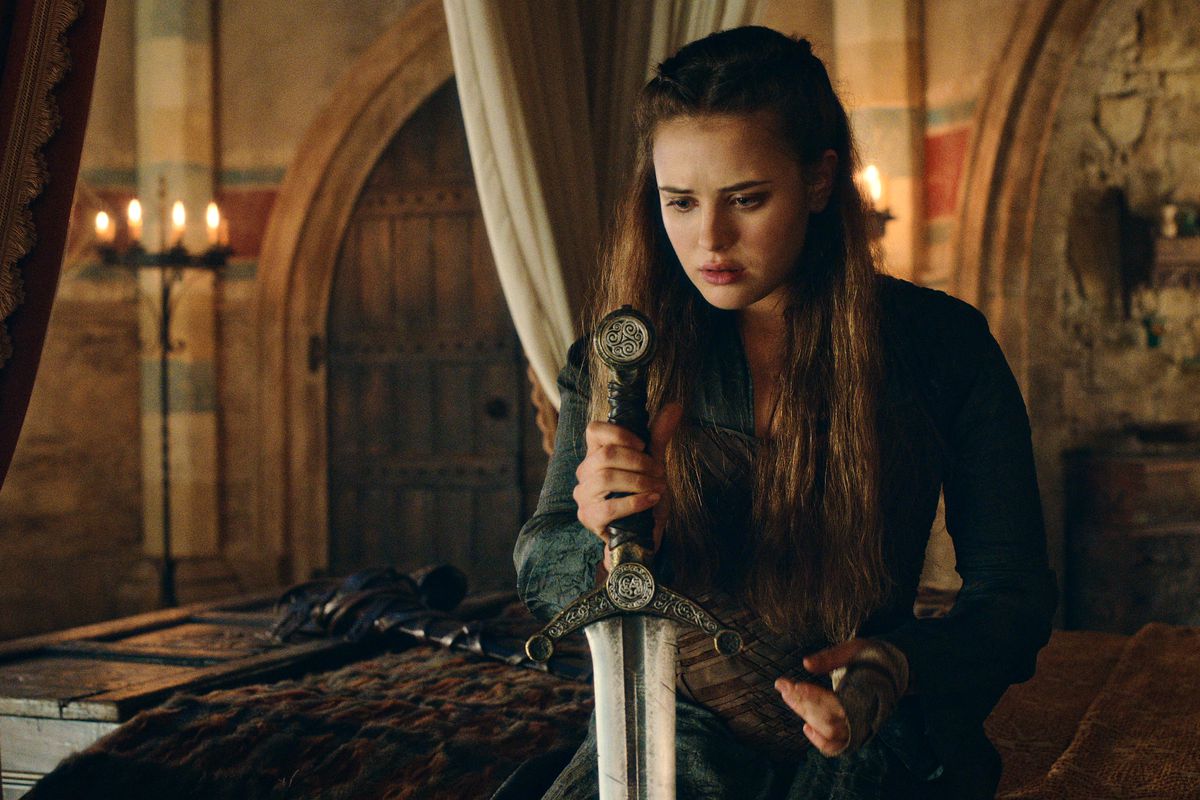 Katherine Langford as Nimue in Cursed, grasping a sword in a bedroom