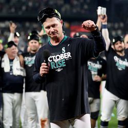 Manager Scott Servais #9 of the Seattle Mariners celebrates after clinching a postseason birth after beating the Oakland Athletics 2-1