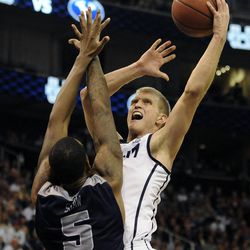 Brigham Young Cougars guard Tyler Haws (3) shoots over Utah State Aggies center Jarred Shaw (5) during a game at EnergySolutions Arena on Saturday, November 30, 2013.