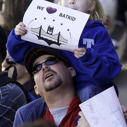 Daniel Fry holds up his daughter Kayla, 5, as they wait for Miles Scott, dressed as Batkid, in San Francisco, Friday, Nov. 15, 2013. San Francisco turned into Gotham City on Friday, as city officials helped fulfill Scott's wish to be "Batkid." Scott, a leukemia patient from Tulelake in far Northern California, was called into service on Friday morning by San Francisco Police Chief Greg Suhr to help fight crime, The Greater Bay Area Make-A-Wish Foundation says.
