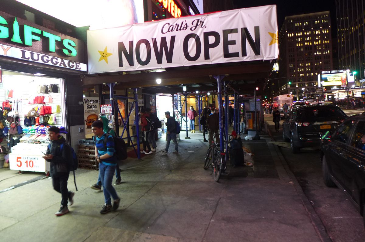 Find Carl’s Jr. underneath a Hooter’s across from Penn Station