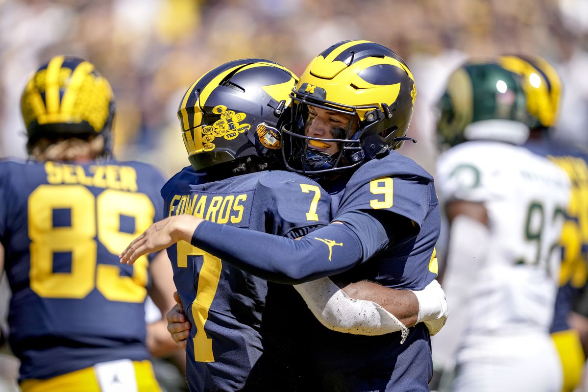 Donovan Edwards of the Michigan Wolverines and J.J. McCarthy of the Michigan Wolverines embrace after McCarthy scored a touchdown against the Colorado State Rams during the second half at Michigan Stadium on September 03, 2022 in Ann Arbor, Michigan.