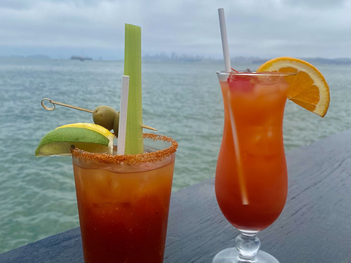 Two cocktails in front of the ocean.