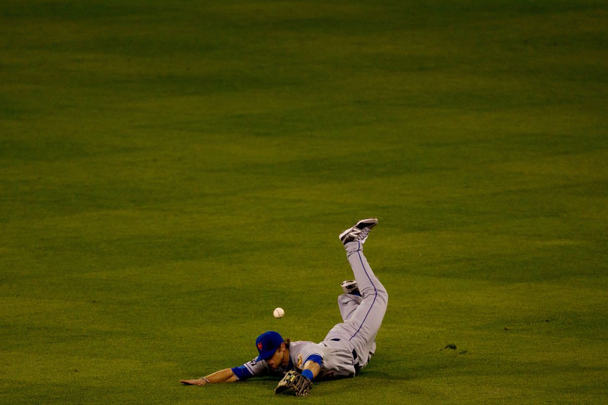 DENVER, CO - APRIL 27:  Center fielder Kirk Nieuwenhuis #9 of the New York Mets comes up short on a diving effort during a game against the Colorado Rockies at Coors Field on April 27, 2012 in Denver, Colorado.  (Photo by Justin Edmonds/Getty Images)
