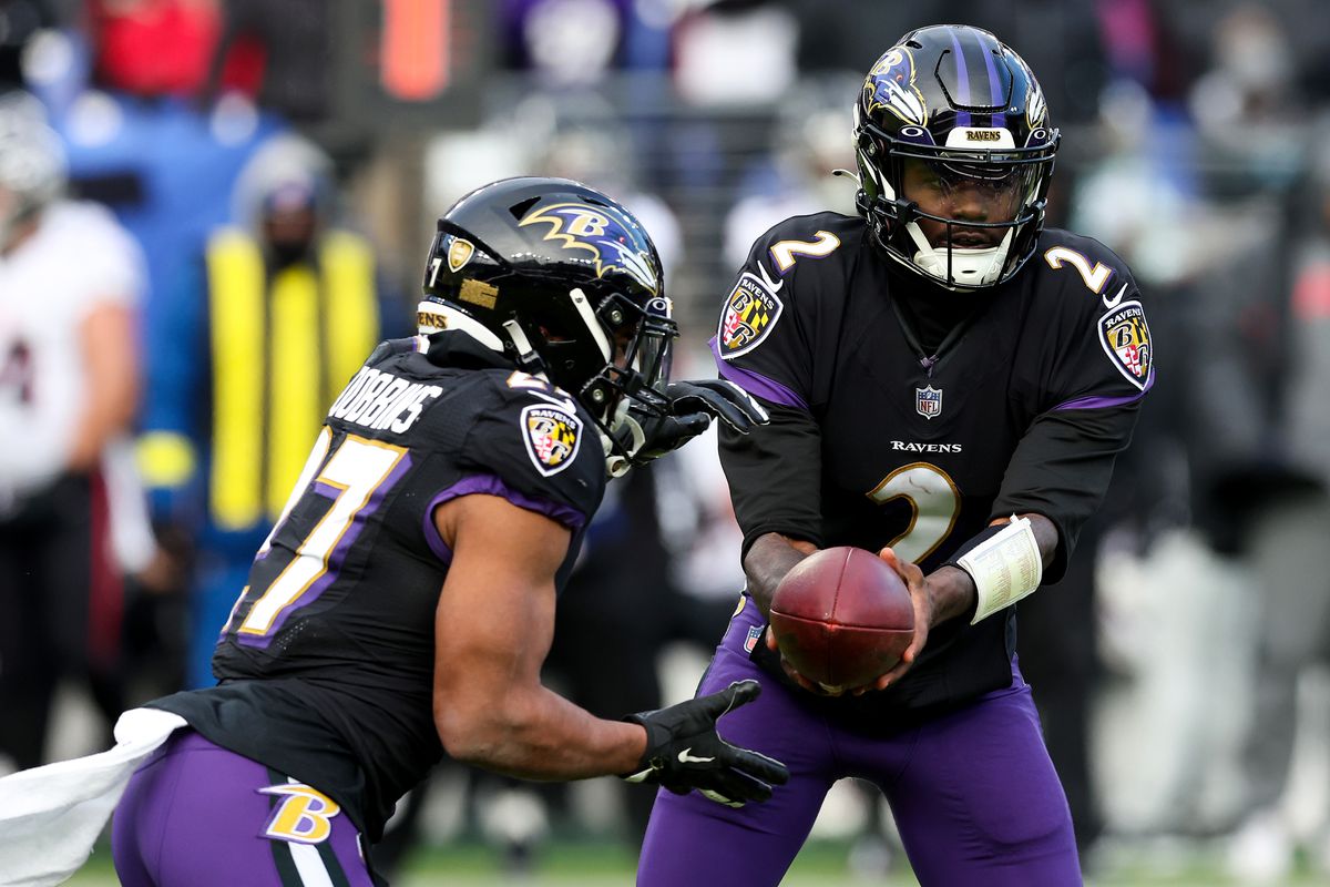 BALTIMORE, MARYLAND - DECEMBER 24: Tyler Huntley #2 of the Baltimore Ravens hands the ball off to J.K. Dobbins #27 during the third quarter against the Atlanta Falcons at M&amp;T Bank Stadium on December 24, 2022 in Baltimore, Maryland.