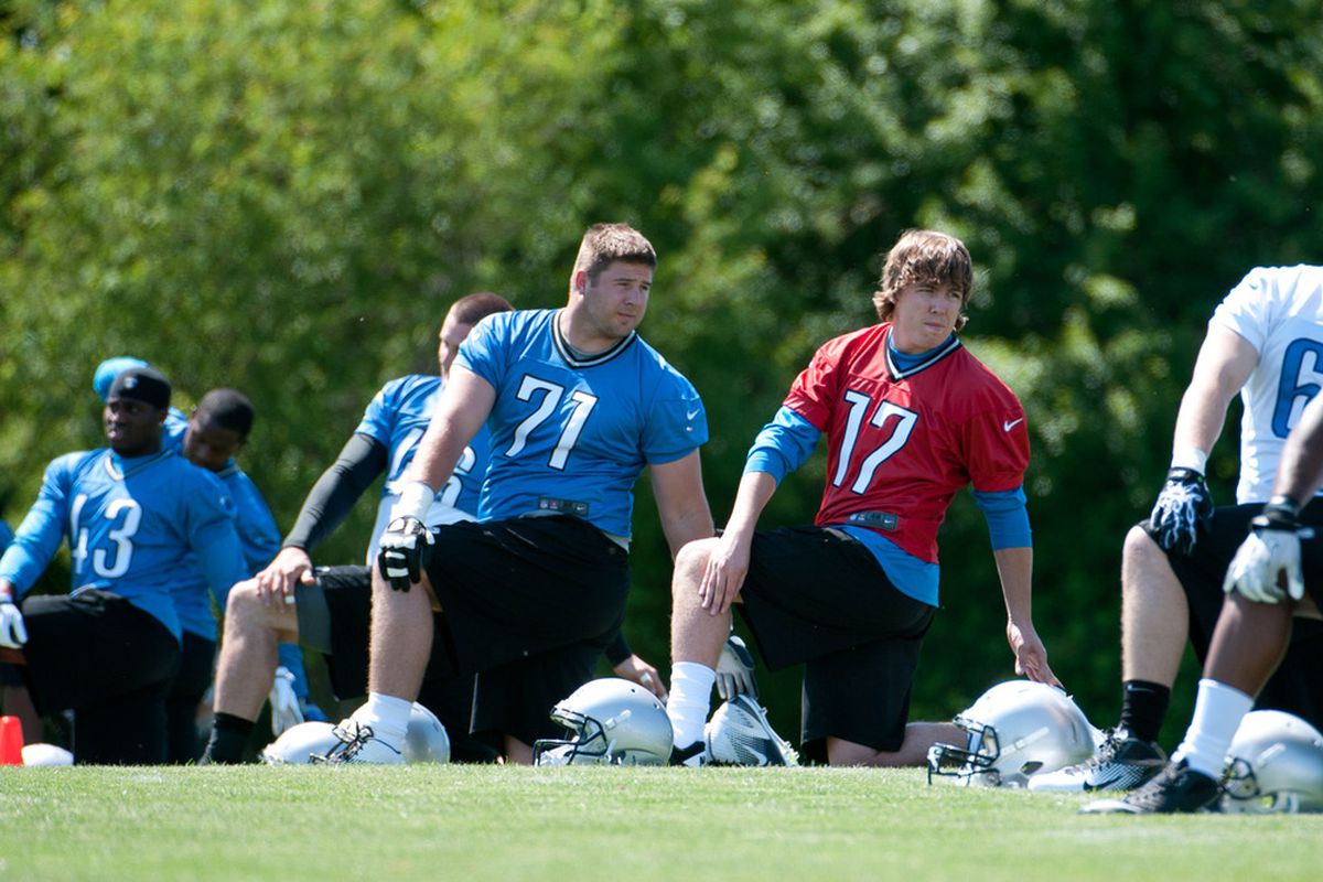 Detroit Lions quarterback Kellen Moore (17) and offensive tackle Riley Reiff (71) warm up during rookie minicamp.