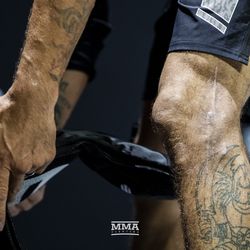 Tony Ferguson puts on his gloves at UFC 229 workouts.