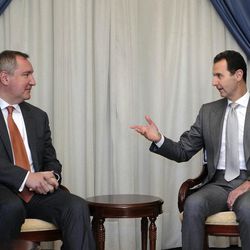In this photo released by the Syrian official news agency SANA, Syrian President Bashar Assad, right, speaks with Russian Deputy Prime Minister Dmitry Rogozin in Damascus, Syria, Tuesday, Nov. 22, 2016. Russia has backed Assad with vast military support as he fights to put down an uprising that is approaching its sixth year. (SANA via AP)