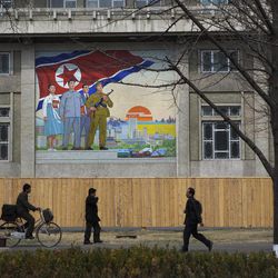 In this Wednesday, April 10, 2013 file photo, North Koreans pass by a large nationalist painting in Pyongyang, North Korea.