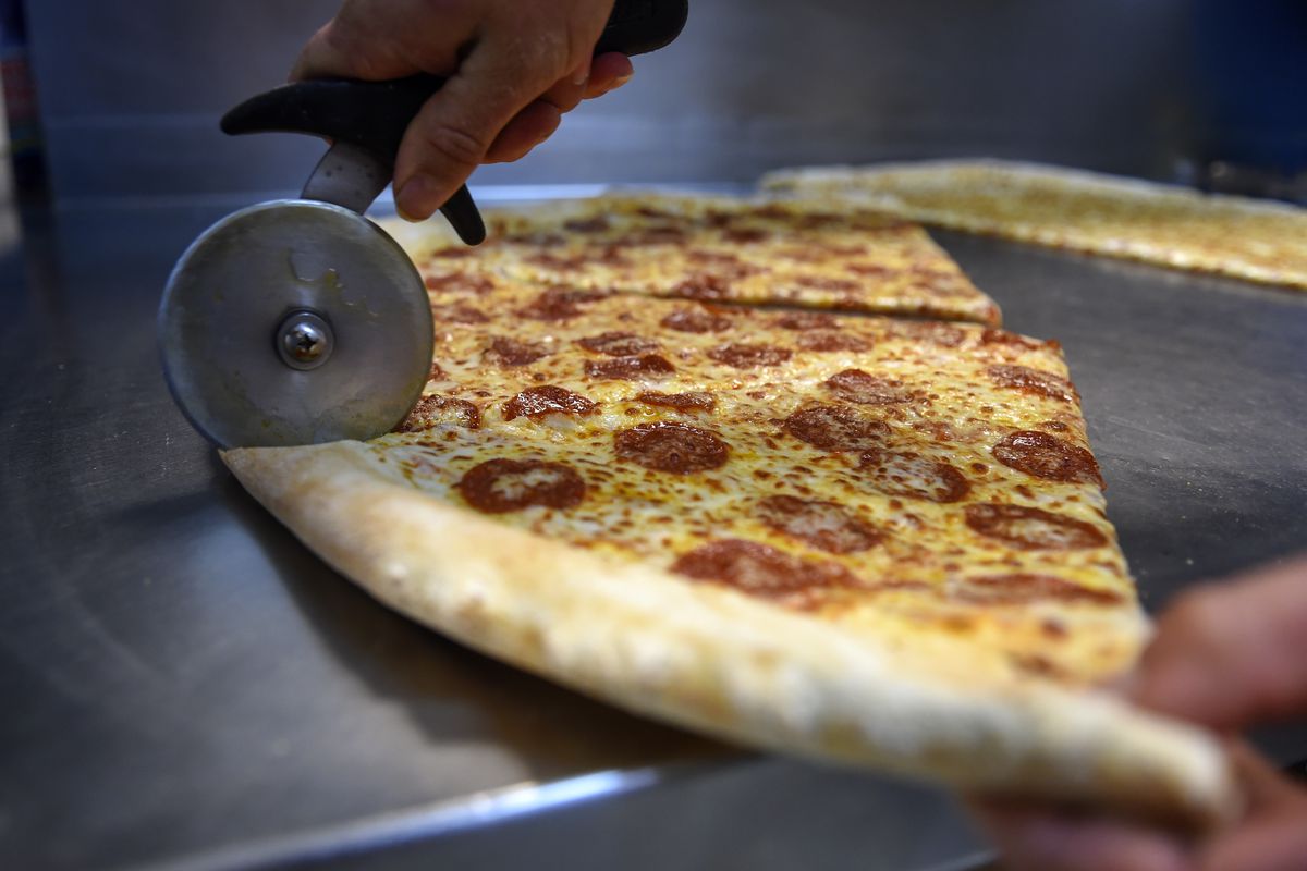 Adams Morgan’s famous “jumbo slice pizza” at Pizza Mart