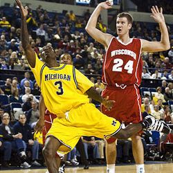 Michigan guard Manny Harris (3) hooks a shot attempt past Wisconsin forward Tim Jarmusz (24) during the first half of an NCAA college basketball game, Saturday in Ann Arbor, Mich. 