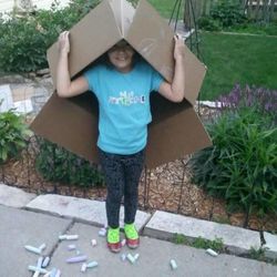Amelia Wardy poses in bright clothes and a box, figuring out ways to "take up space in the world," in her mother's words.