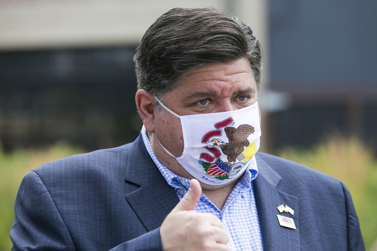 Gov. J.B. Pritzker during a meeting with residents at City Market in Rockford in July.