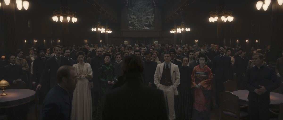 In a still from 1899, the passengers of the Kerberos stand facing forward in the ship’s dining hall.