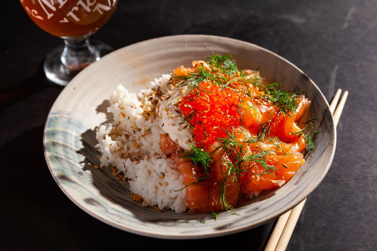 A plate with rice and cured salmon.