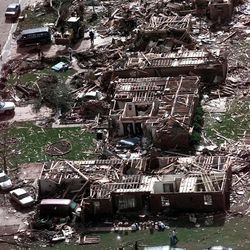 FILE - In this Tuesday, May 4, 1999, photo, a neighborhood in Moore, Okla., lays in ruins pm Tuesday, May 4, 1999, after a tornado flattened many houses and buildings in central Oklahoma, Monday, night. The powerful tornado in suburban Oklahoma City Monday, May 20, 2013, loosely followed the path of a killer twister that slammed the region in May 1999. (AP Photo/J. Pat Carter, File)