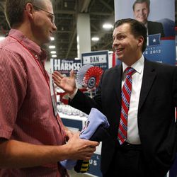 Nolan Kerr talks to Dan Liljenquist, right, at the Salt Lake County GOP convention at the Salt Palace Convention Center in Salt Lake City on Saturday, April 14, 2012. 