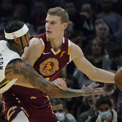Utah Jazz’s Jordan Clarkson (00) puts pressure on Cleveland Cavaliers’ Lauri Markkanen (24) in the first half of an NBA basketball game, Sunday, Dec. 5, 2021, in Cleveland. 