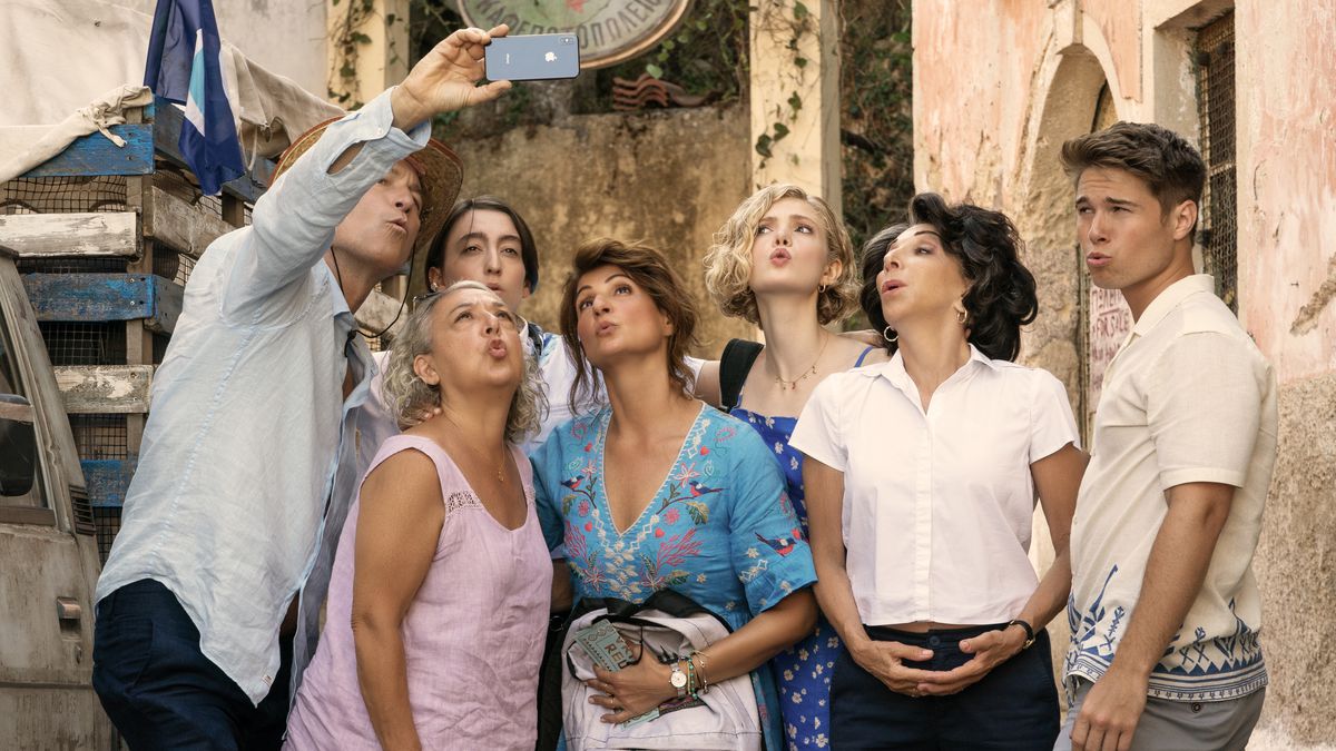 The Portokalos family poses for a group selfie while making silly puckering faces in the streets of a Greek village in My Big Fat Greek Wedding 3