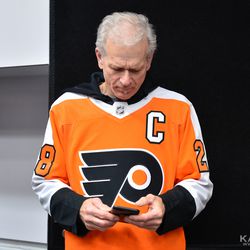 Claude’s father watching recaps from the game on his phone