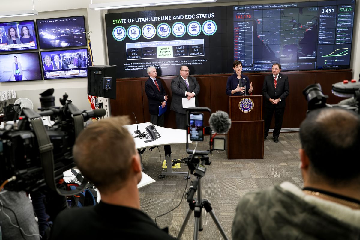 Dr. Angela Dunn, Utah state epidemiologist, speaks alongside Gov. Gary Herbert, right, during a press conference in the Emergency Operations Center at the Capitol in Salt Lake City on Friday, March 6, 2020. Officials announced the first known case of COVID-19 diagnosed in Utah. Also appearing are Dr. Joseph Miner, executive director of the Utah Department of Health, left, and Brian Hatch, director of the Davis County Health Department, second from left.