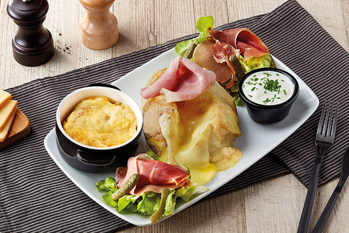 Pom’ au four Savoyarde, a baked potato topped with ham and cheese