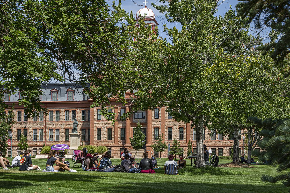 Regis University students gather outside for class during the first week of the 2020 fall semester.