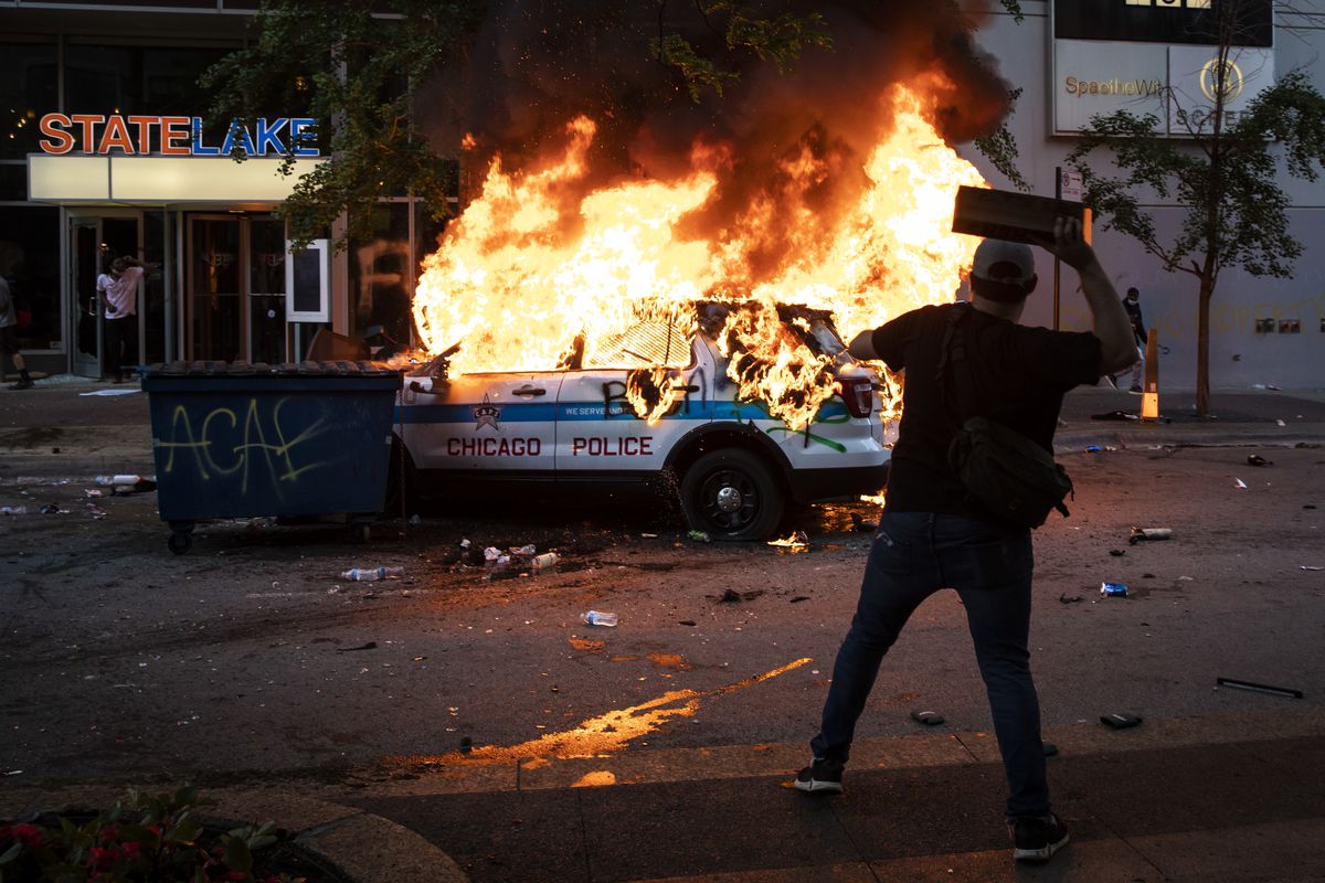 A Chicago Police Department SUV is set on fire near State and Lake in the Loop as thousands of protesters in Chicago joined national outrage over the killing of George Floyd in Minneapolis police custody, Saturday afternoon, May 30, 2020.