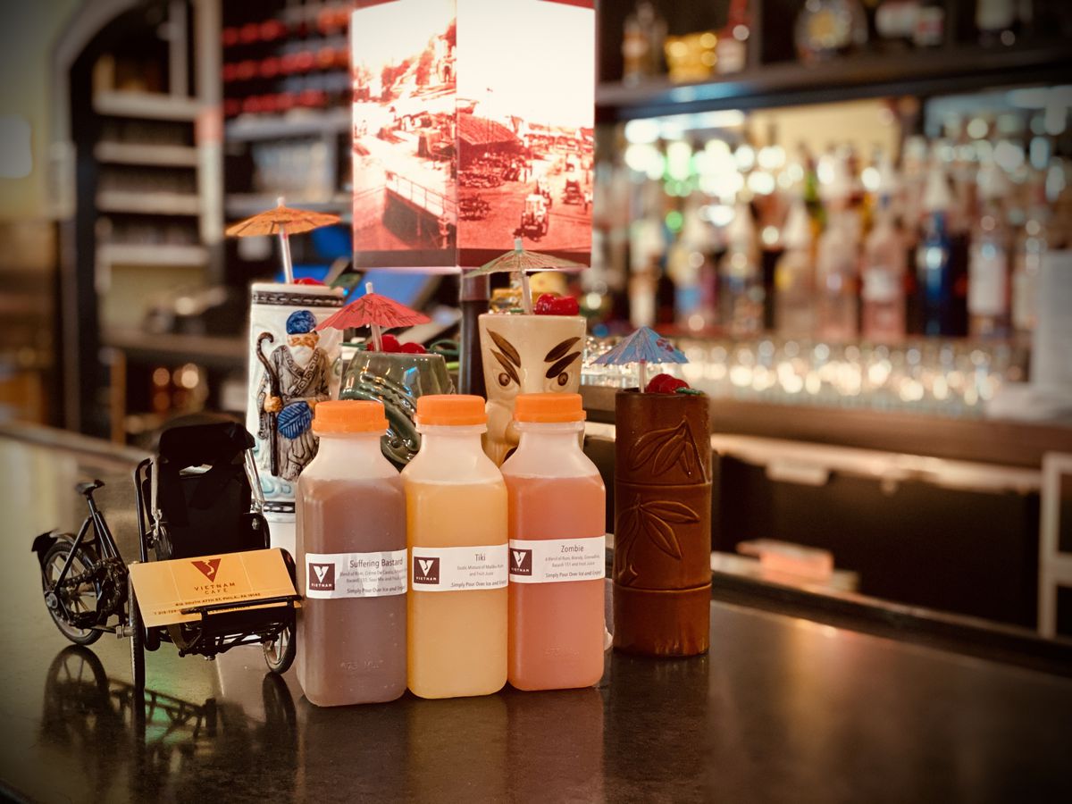 row of juice containers with labels on a bar
