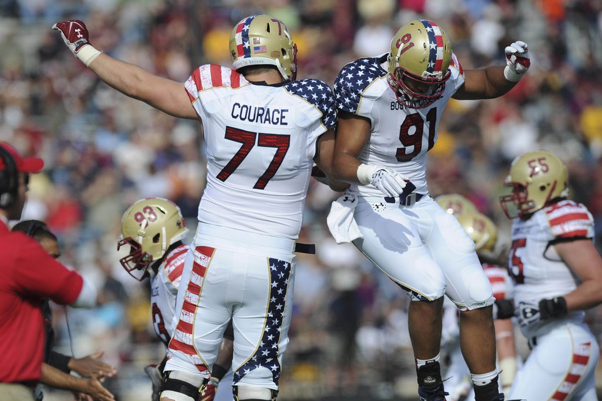 October 26, 2012; Boston, MA USA; Boston College Eagles offensive tackle Emmett Cleary (77) and defensive end Kasim Edebali (91) react after a play during the first half against the Maryland Terrapins at Alumni Stadium. 