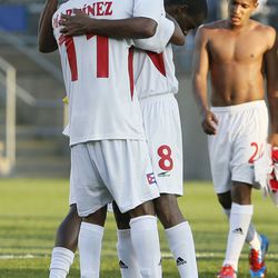 Cuba midfield Ariel Martinez (11) and Cuba midfield Jaine Colome (8) celebrate their win over Belize.