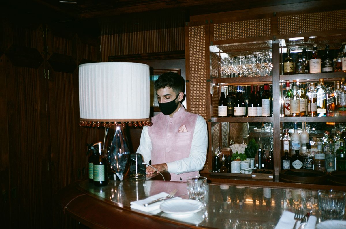A bartender prepares drinks for guests inside Gymkhana, the Michelin-Starred Mayfair restaurant by JKS Restaurants