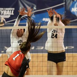 BYU’s Whitney	Bower, left and Kennedy Eschenberg blocks the shot of Utah’s Danie Drews (1) in an NCAA volleyball game at Smith Fieldhouse in Provo on Saturday, Dec. 4, 2021.
