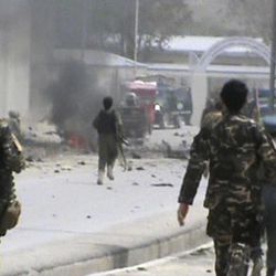 This image made from AP video shows Afghan National Army soldiers rushing to the scene moments after a car bomb exploded in front the PRT, Provincial Reconstruction Team, in Qalat, Zabul province, southern Afghanistan, Saturday, April 6, 2013. Three U.S.  soldiers, two U.S. civilians and a doctor were killed when a suicide bomber detonated a car full of explosives just as a convoy with the international military coalition drove past another convoy of vehicles carrying the governor of Zabul province. (AP Photo via AP video)