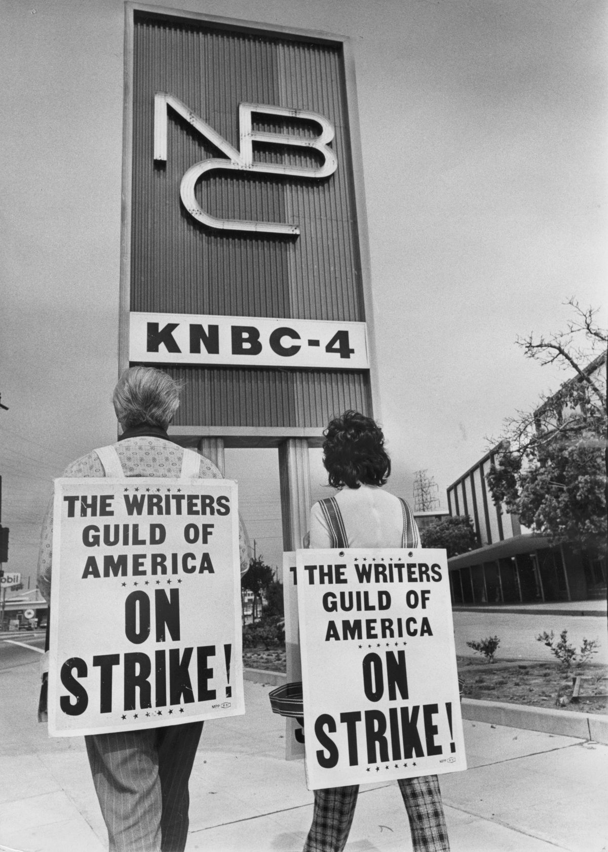 Two writers on strike in front of the NBC office.